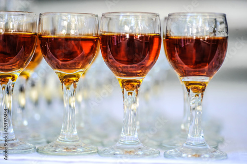 close up photo of rows of glasses with cognac on the table