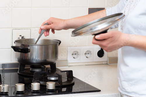 Wife prepares her husband for dinner in the kitchen