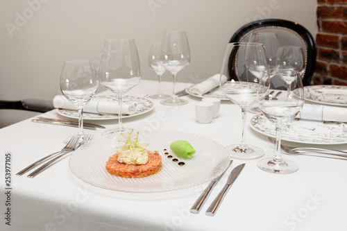 Salmon tartare with creamy sauce  sorbet and apple on restaurant table