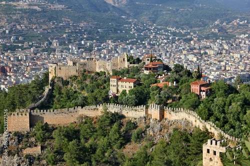 View of the northern part of the fortress of Alanya, the central attraction of the city, one of the key historical monuments on a blurred background