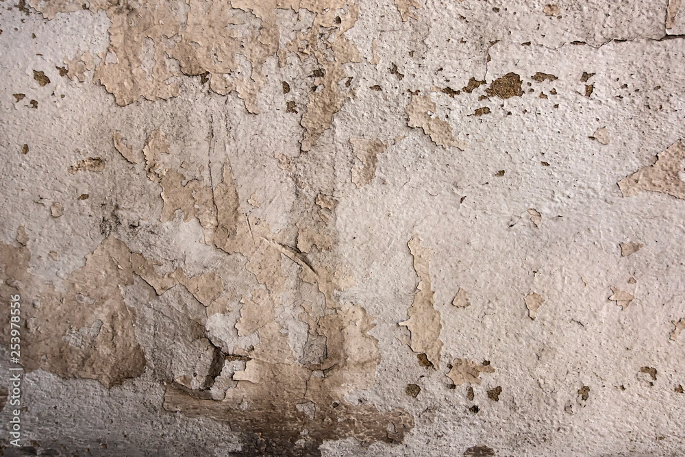 A peeling paint aged white wall texture background A peeling paint aged white wall texture background