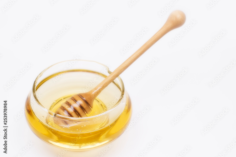 Honey pot and dipper isolated on white background, copy text Honey pot and dipper isolated on white background, copy text