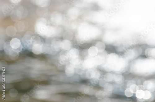 Bokeh caused by the reflection of light from the water and the background with blurred patterns