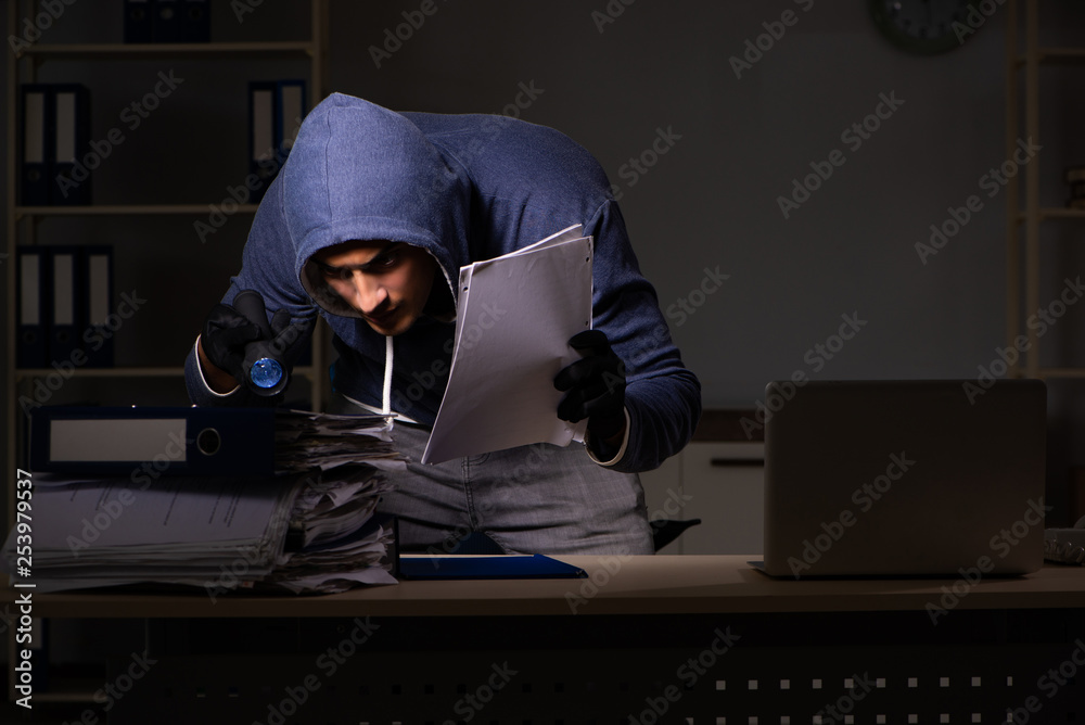 Thief trying to steal personal data in identity theft concept Thief trying to steal personal data in identity theft concept