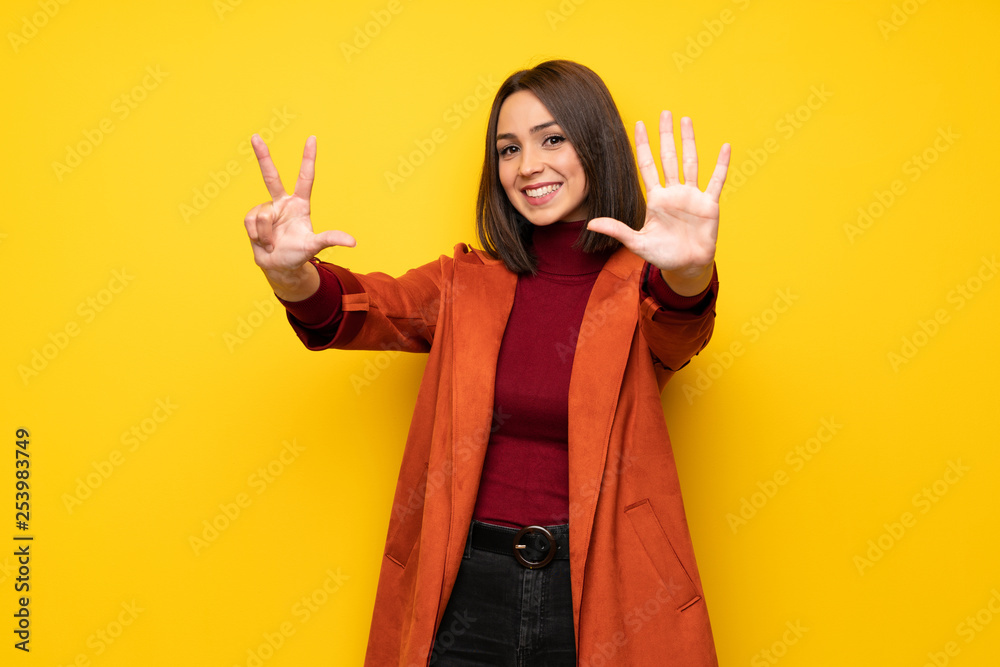 Young woman with coat counting eight with fingers Young woman with coat counting eight with fingers