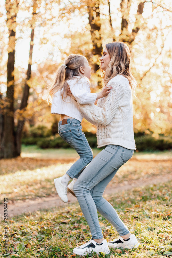 Happy daughter with mother is having fun walking in the park. Happy daughter with mother is having fun walking in the park.