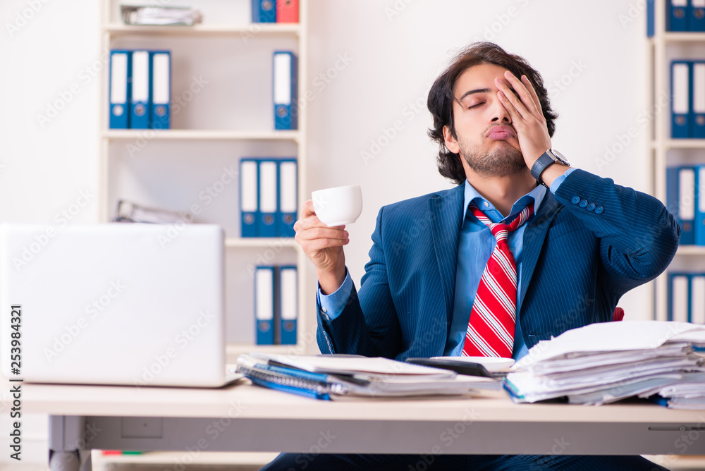 Young handsome businessman sitting in the office Young handsome businessman sitting in the office