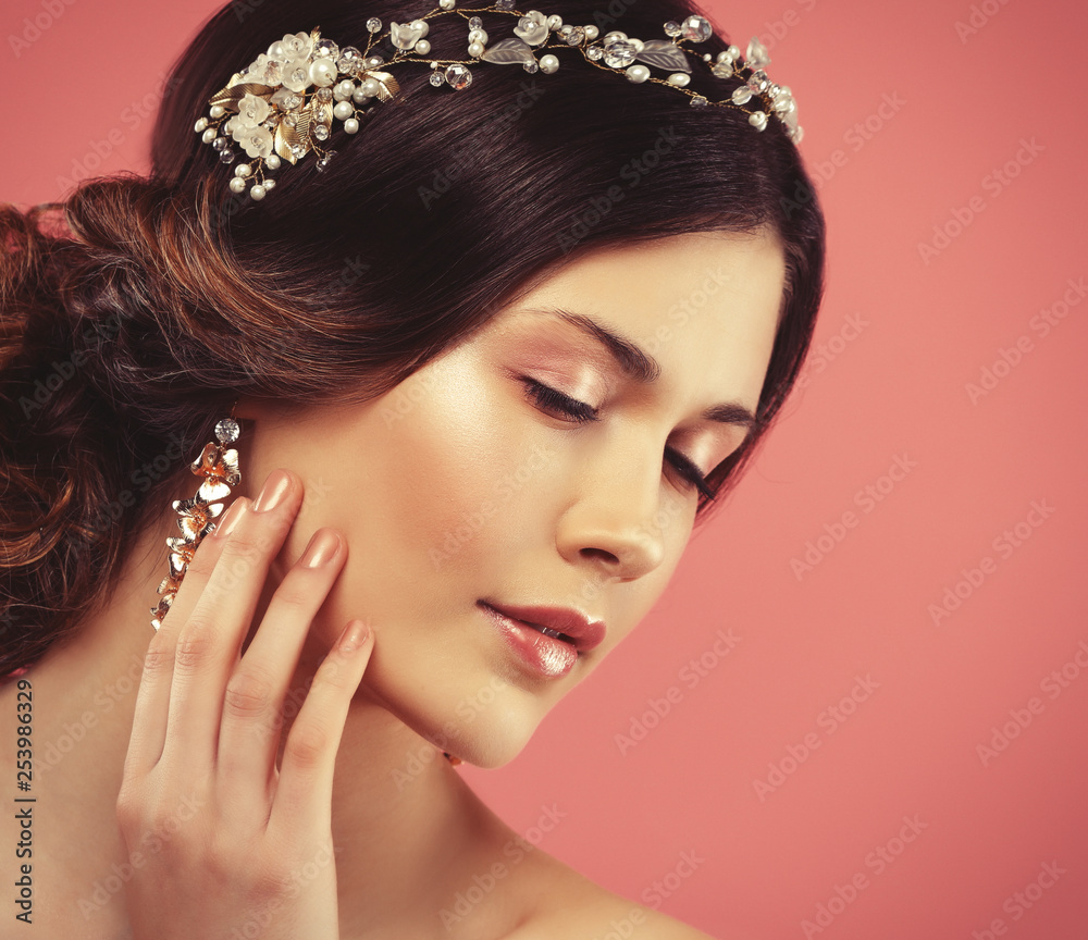 Fototapeta premium Wedding earrings on a female hand, she takes the earrings, wear earrings.