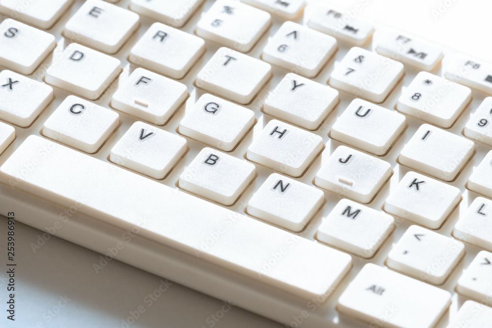 White keyboard for computer. Close-up. Background for design on the topic of information technology. White keyboard for computer. Close-up. Background for design on the topic of information technology.