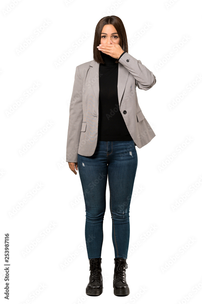 A full-length shot of a Young business woman covering mouth with hands for saying something inappropriate over isolated white background A full-length shot of a Young business woman covering mouth with hands for saying something inappropriate over isolated white background