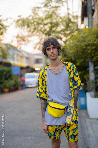 Fényképezés Portrait of young rebellious man standing in the streets outdoors