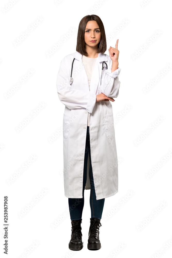 A full-length shot of a Young doctor woman thinking an idea pointing the finger up over isolated white background A full-length shot of a Young doctor woman thinking an idea pointing the finger up over isolated white background