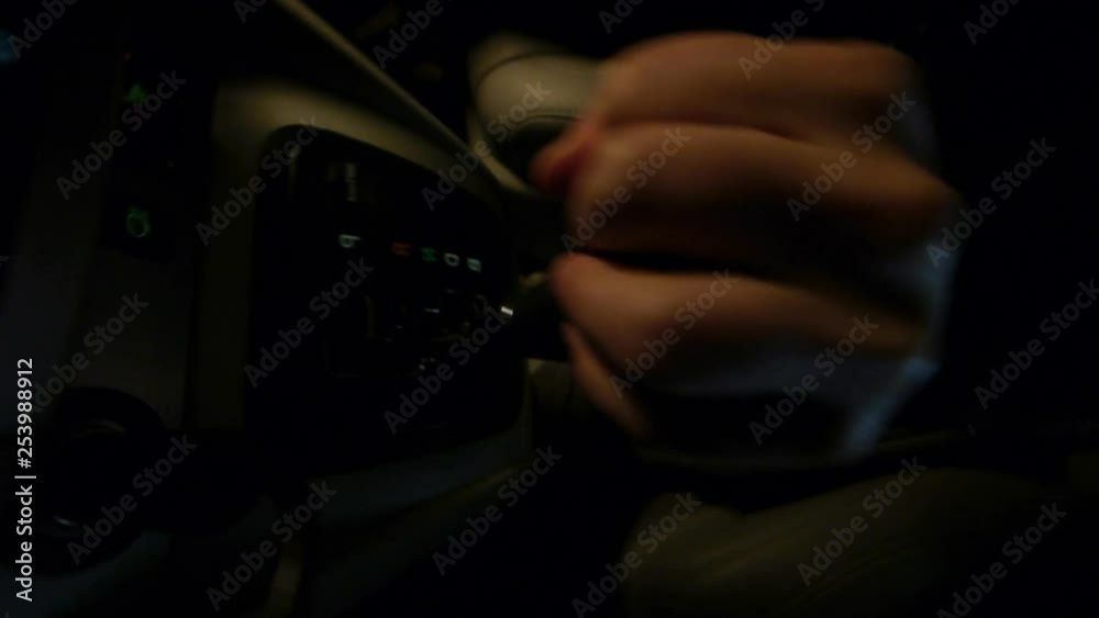 Car driving in gritty downtown city streets with buildings at night. Car driving in gritty downtown city streets with buildings at night.