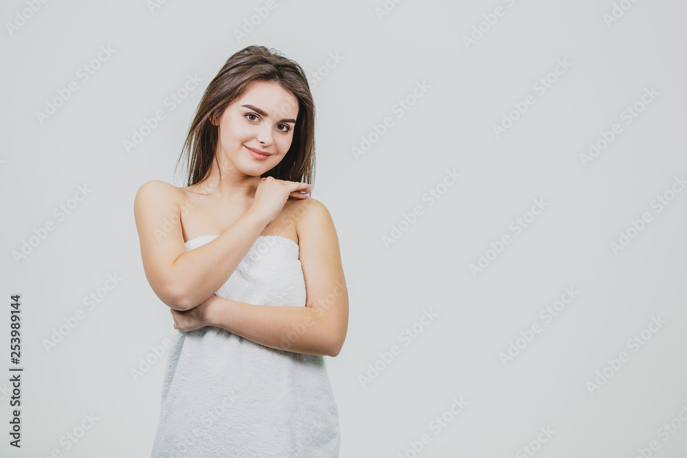 Beautiful Young Woman with Clean Fresh Skin touch own face . Facial treatment . Cosmetology. Beauty and spa .The girl looks to the side, putting her hand on her shoulder. Beautiful Young Woman with Clean Fresh Skin touch own face . Facial treatment . Cosmetology. Beauty and spa .The girl looks to the side, putting her hand on her shoulder.
