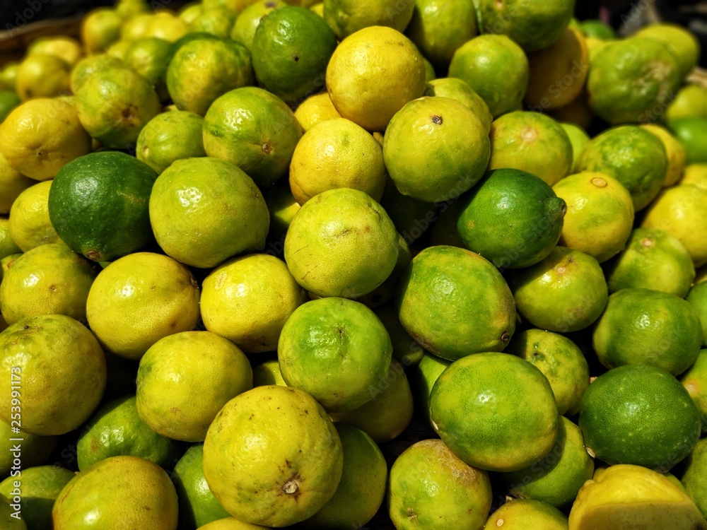 a pile of fresh lime lemon yellow green