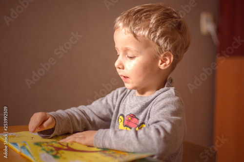 little child learns to read a book