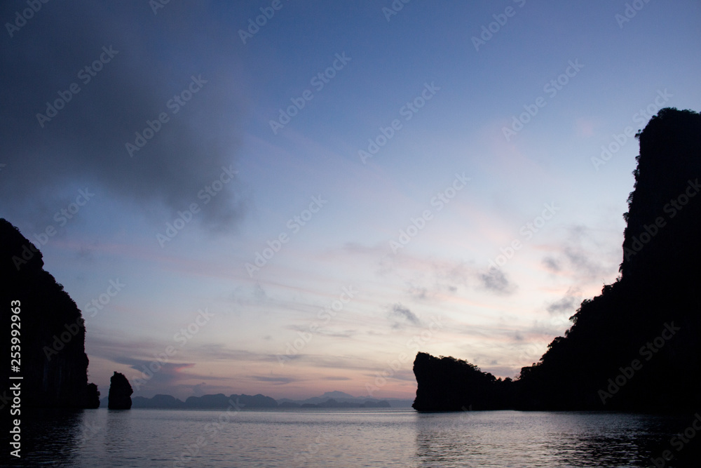 Blue skies and an island silhouette in Phuket, Thailand