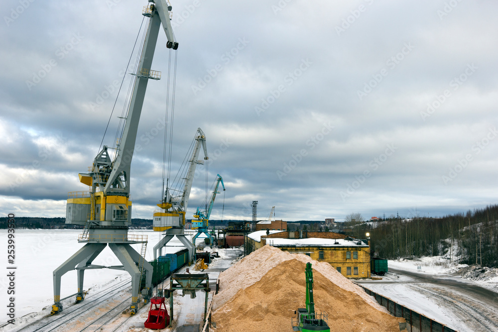 cargo port in winter. Unloading of wood chips from railway cars