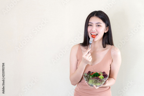 Lifestyle beautiful beauty woman Asian cute girl feel happy enjoy eating diet food fresh salad for good health in the morning