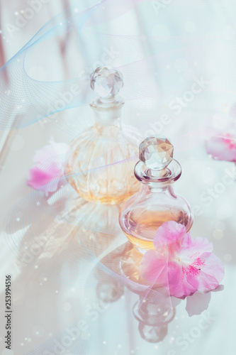 Fototapeta Naklejka Na Ścianę i Meble -  Spa still life with perfume and aromatic oils bottles surrounded by flowers