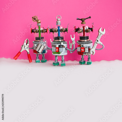 Three funny handyman robots ready for maintenace and repair. Robotic characters with pliers hand wrench pink gray background. Copy space