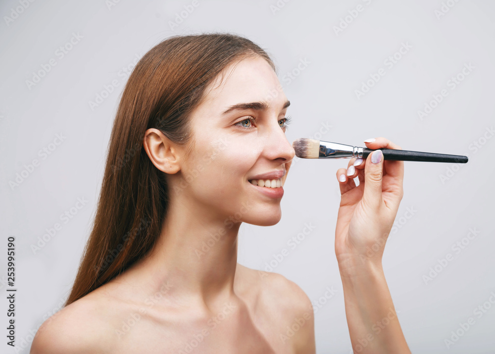Close up woman getting make up on cheeks, visage concept Close up woman getting make up on cheeks, visage concept