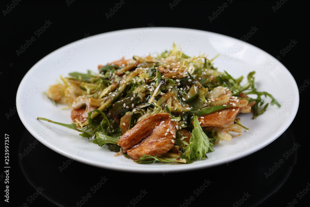 salad of a large amount of greens, green celery, arugula, boiled meat fillet with sauce and sesame salad of a large amount of greens, green celery, arugula, boiled meat fillet with sauce and sesame