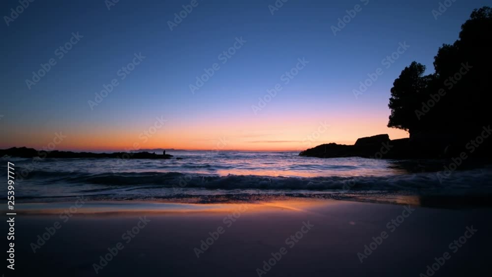 Slider shot at dusk along the Mediterranean sea, red-blue sky Slider shot at dusk along the Mediterranean sea, red-blue sky