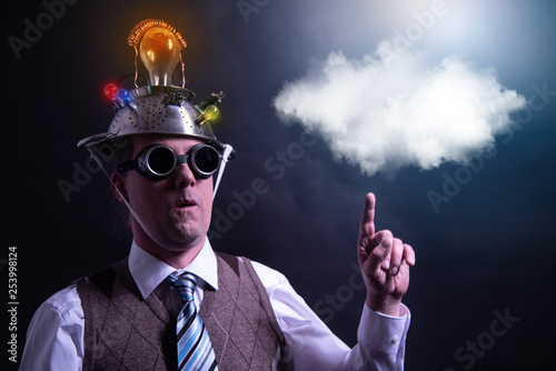 distraught looking conspiracy believer in suit with aluminum foil head with chemtrails cloud chemtrail