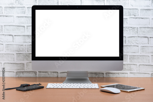 Blank screen of All in one Computer with tablet, smart phone and smart watch on wooden table, White brick wall background