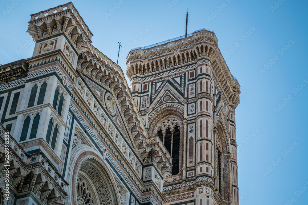 View on Campanile di Giotto and detail of the facade of the Basilica di Santa Maria del Fiore in Firenze, Italy