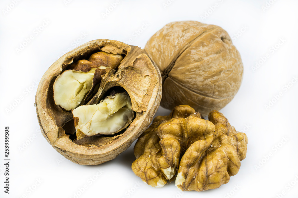 Broken and whole walnuts isolated on a white background. Broken and whole walnuts isolated on a white background.