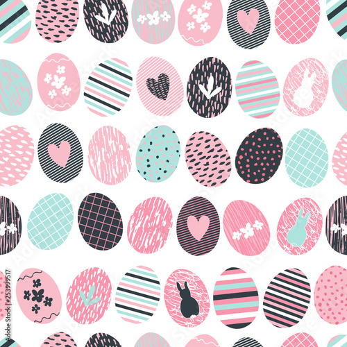 Cute and sweet seamless repeated pattern background with decorated and textured easter eggs in rows