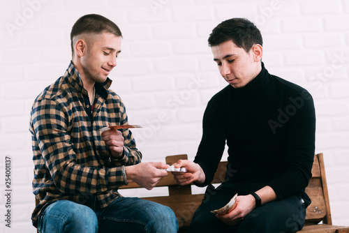 men on the bench selling drugs or pills for rubles