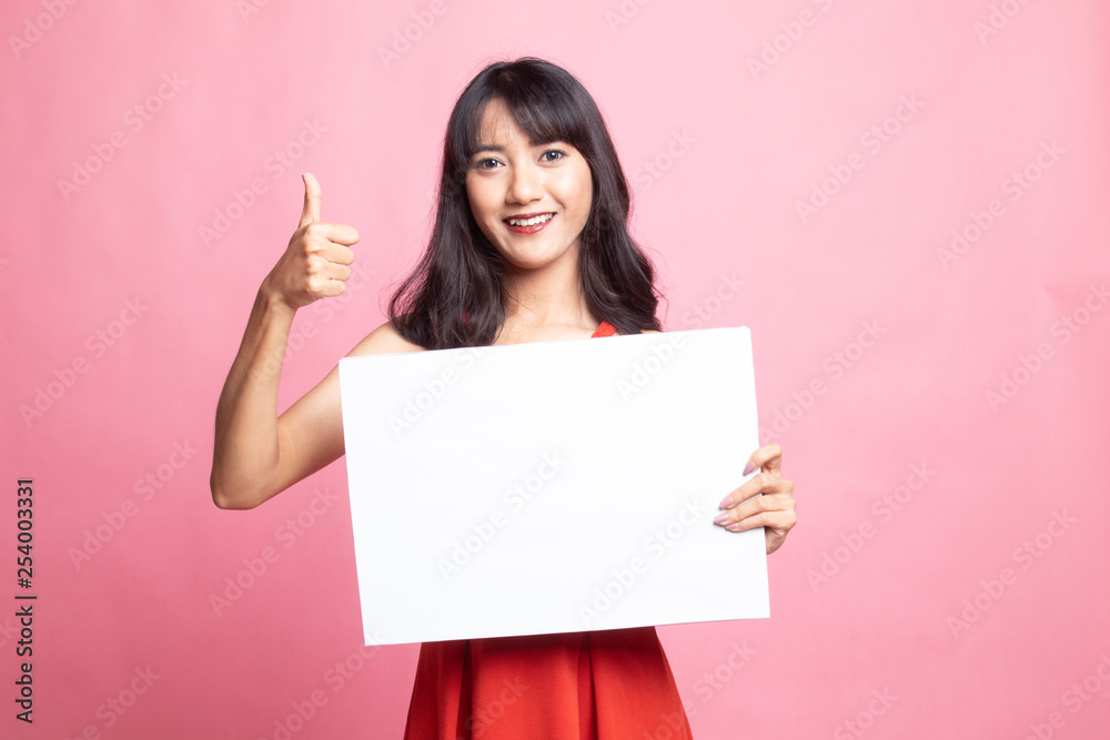 Young Asian woman show thumbs up with white blank sign. Young Asian woman show thumbs up with white blank sign.