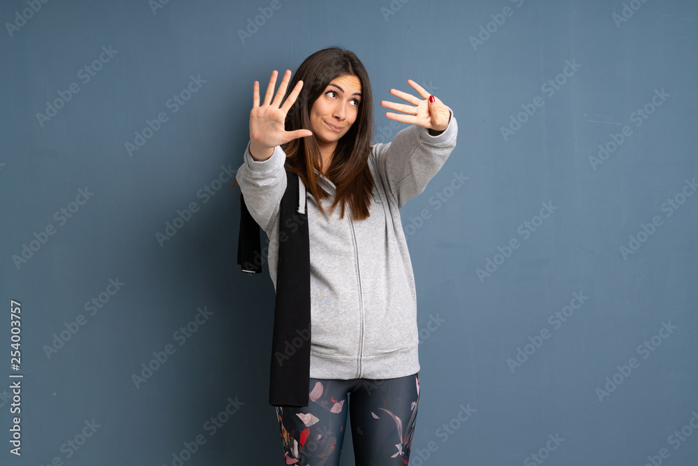 Young sport woman counting nine with fingers Young sport woman counting nine with fingers