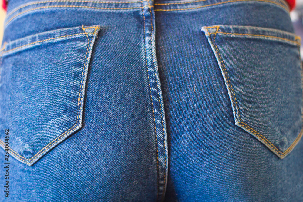 Fototapeta premium Female ass in jeans closeup