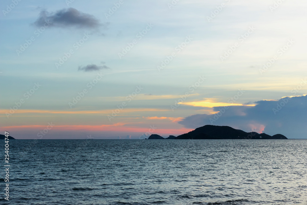 beautiful seascape, sunset behind island and above the sea at asia