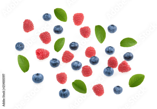 Raspberries and blueberries white background top view