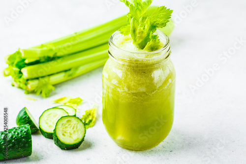 Green detox celery cucumber juice in a jar.