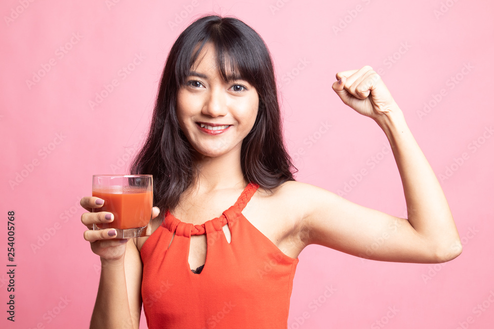 Strong healthy Asian woman with tomato juice. Strong healthy Asian woman with tomato juice.
