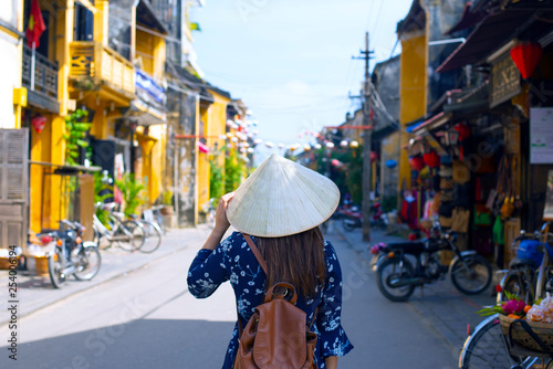 Woman tourist is travel into old town village in Hoi An, Vietnam.