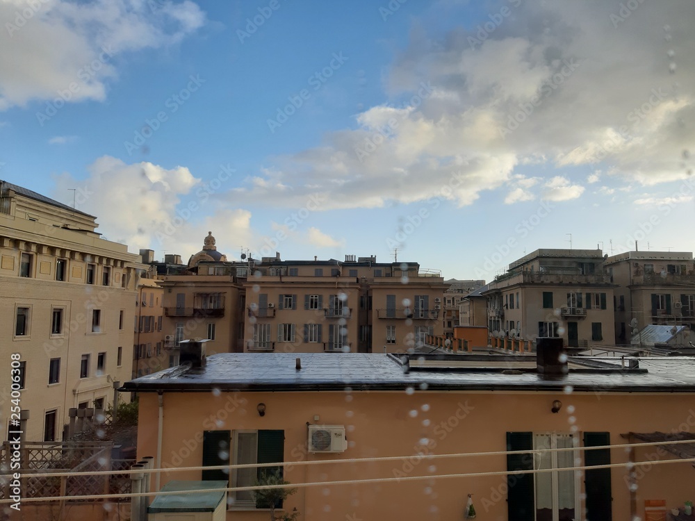 Genova, Italy - 03/05/2019: An amazing caption of the waterdro on the window with beautiful background of a blue sky and some white clouds.