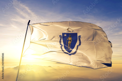 Massachusetts state of United States flag waving on the top sunrise mist fog photo