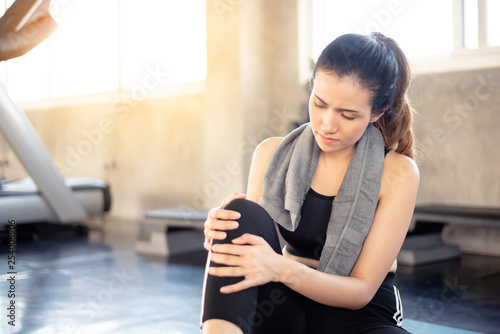 Young asian girl suffering or injury leg after exercise