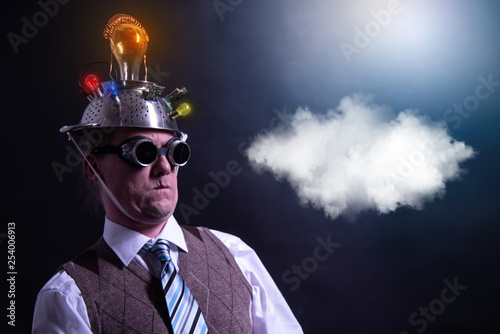 distraught looking conspiracy believer in suit with aluminum foil head with chemtrails cloud chemtrail photo