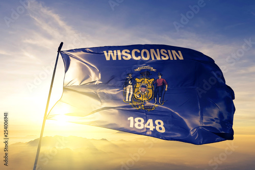 Wisconsin state of United States flag waving on the top sunrise mist fog photo