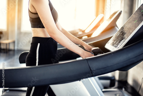 Young Asian woman exercising on treadmill at a gym