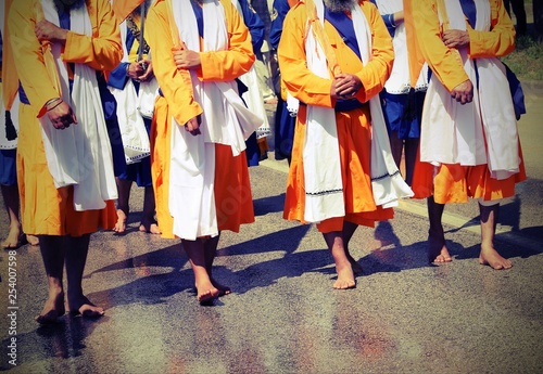 barefoot Sikh religion men during the parade in the city streets