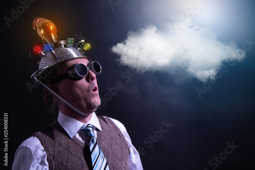 distraught looking conspiracy believer in suit with aluminum foil head with chemtrails cloud chemtrail